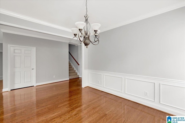 5592 Summit Pointe, Pinson, AL 35126 - unfurnished dining area with ornamental molding, a chandelier, stairway, wainscoting, and wood finished floors