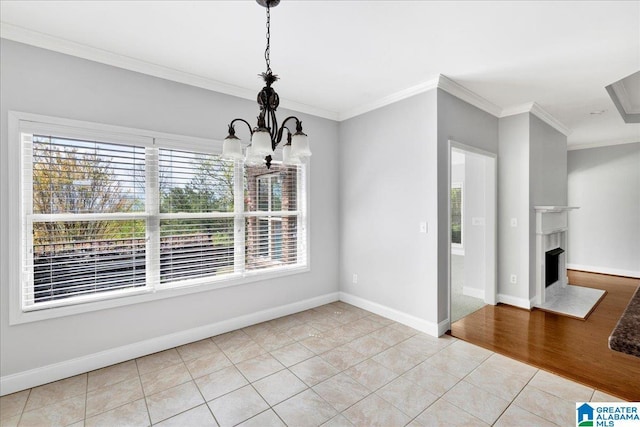 5592 Summit Pointe, Pinson, AL 35126 - unfurnished dining area featuring baseboards, a notable chandelier, a fireplace, crown molding, and tile patterned floors
