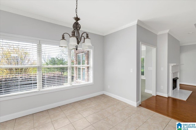 5592 Summit Pointe, Pinson, AL 35126 - unfurnished dining area with crown molding, light tile patterned floors, a fireplace with flush hearth, a notable chandelier, and baseboards
