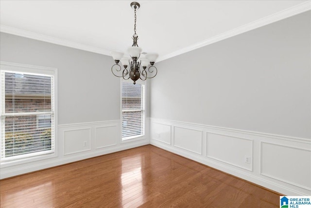5592 Summit Pointe, Pinson, AL 35126 - spare room featuring a chandelier, ornamental molding, a wainscoted wall, and wood finished floors