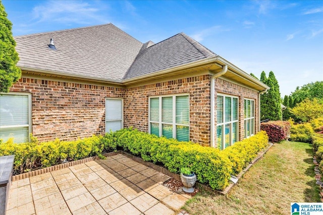 5592 Summit Pointe, Pinson, AL 35126 - view of side of home with a patio, a yard, roof with shingles, and brick siding