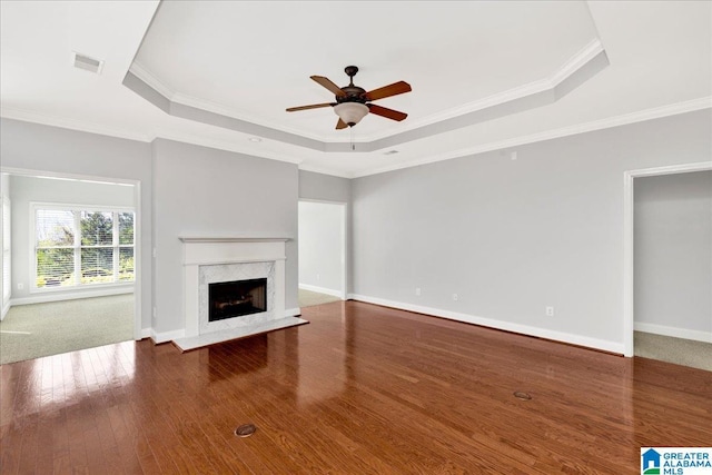 5592 Summit Pointe, Pinson, AL 35126 - unfurnished living room with baseboards, a raised ceiling, a ceiling fan, a high end fireplace, and wood finished floors