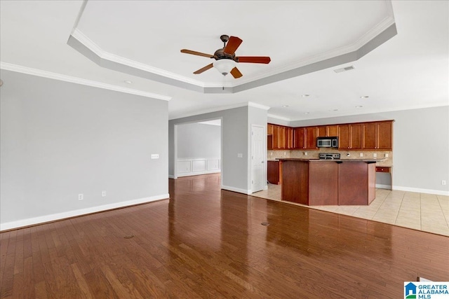 5592 Summit Pointe, Pinson, AL 35126 - unfurnished living room featuring a ceiling fan, crown molding, visible vents, a raised ceiling, and light wood finished floors