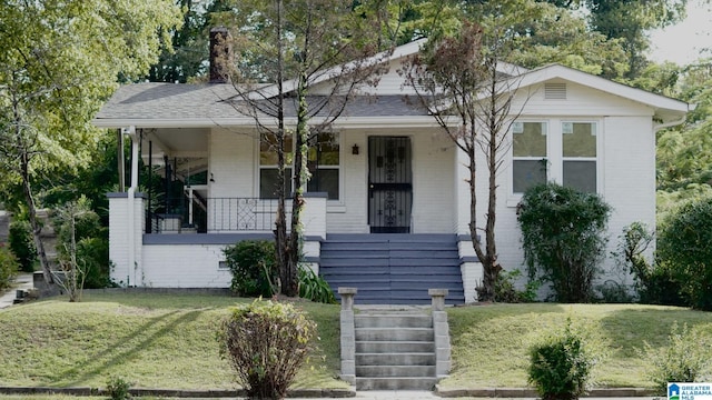 1501 Graymont Ave W, Birmingham, AL 35208 - view of front facade featuring brick siding, a porch, and a front lawn
