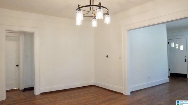1501 Graymont Ave W, Birmingham, AL 35208 - unfurnished room featuring an inviting chandelier, baseboards, and dark wood-type flooring