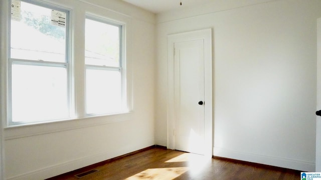 1501 Graymont Ave W, Birmingham, AL 35208 - spare room with dark wood finished floors, visible vents, baseboards, and plenty of natural light