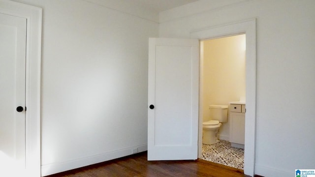 1501 Graymont Ave W, Birmingham, AL 35208 - bathroom featuring baseboards, wood finished floors, and toilet