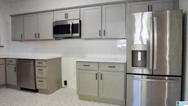 1501 Graymont Ave W, Birmingham, AL 35208 - kitchen featuring light countertops, gray cabinets, stainless steel appliances, and tasteful backsplash