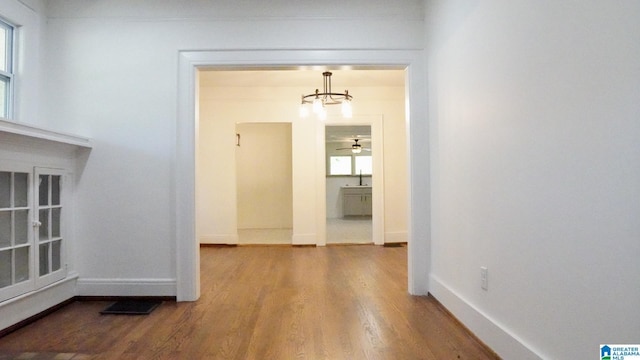 1501 Graymont Ave W, Birmingham, AL 35208 - hall featuring a sink, wood finished floors, a chandelier, and baseboards