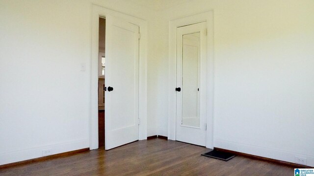 1501 Graymont Ave W, Birmingham, AL 35208 - unfurnished bedroom featuring dark wood-style flooring and baseboards
