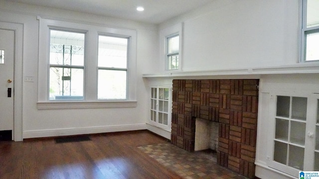 1501 Graymont Ave W, Birmingham, AL 35208 - unfurnished living room with dark wood-style floors, visible vents, and plenty of natural light