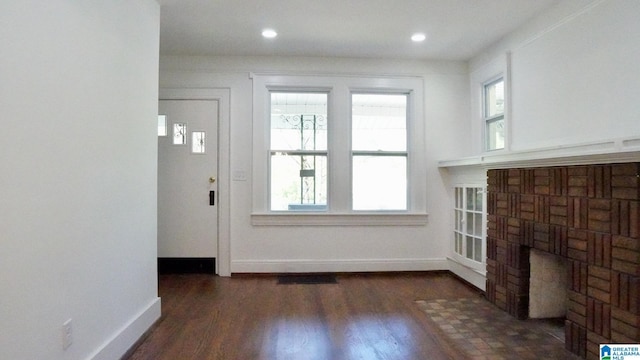 1501 Graymont Ave W, Birmingham, AL 35208 - unfurnished living room featuring a wealth of natural light, wood finished floors, and baseboards