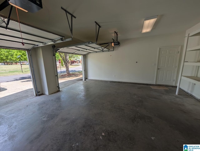 4206 Shinnecock Cir, Bessemer, AL 35022 - garage featuring baseboards and a garage door opener