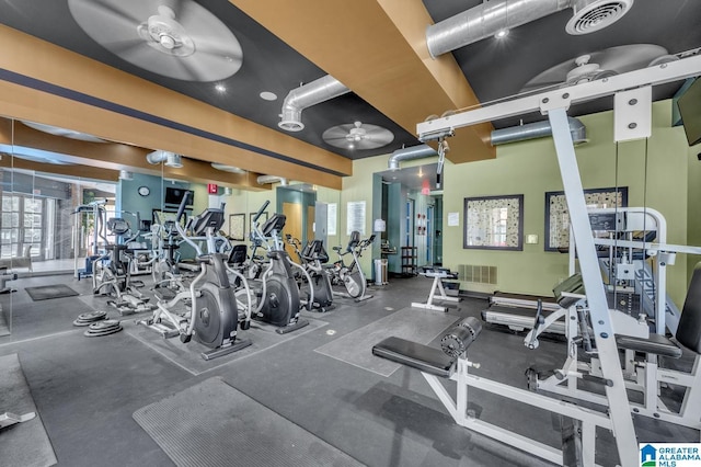 exercise room with visible vents and ceiling fan