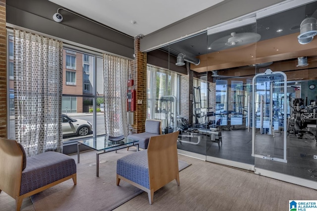 interior space featuring brick wall and wood finished floors