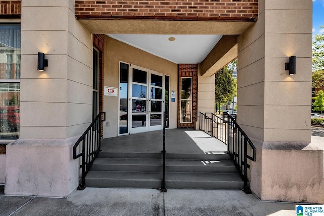 view of exterior entry featuring brick siding