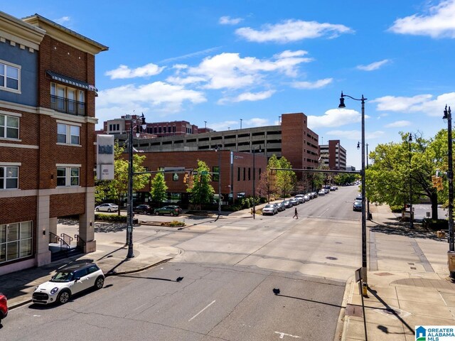 view of road with street lighting, sidewalks, and curbs