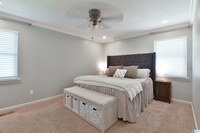 bedroom featuring multiple windows, light carpet, visible vents, and crown molding