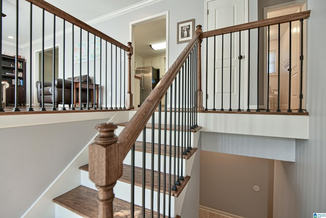 staircase featuring crown molding