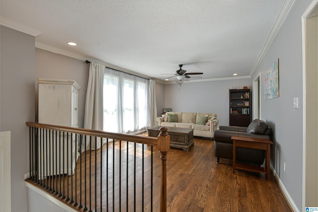 living room with dark wood finished floors, ceiling fan, and crown molding