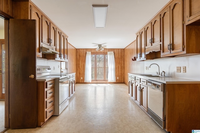 kitchen with ceiling fan, white appliances, under cabinet range hood, light countertops, and a sink