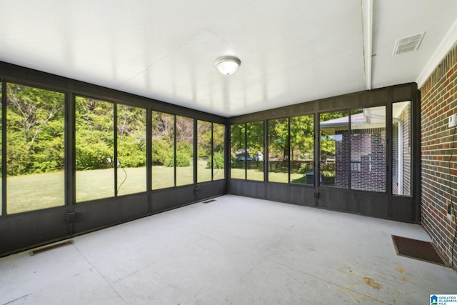unfurnished sunroom featuring visible vents