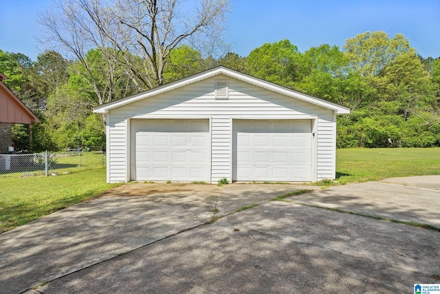 detached garage featuring fence