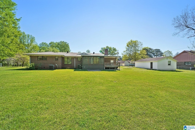 view of yard with central AC and a sunroom