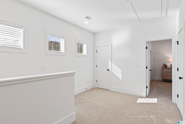 299 Williams Rd, Alexander City, AL 35010 - unfurnished room featuring visible vents, baseboards, attic access, and light carpet