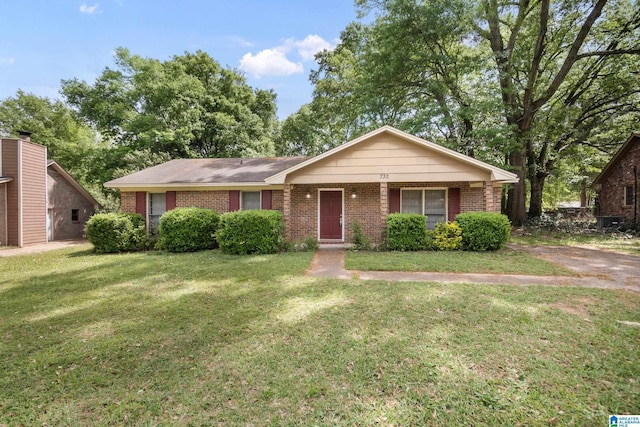 single story home featuring brick siding and a front lawn