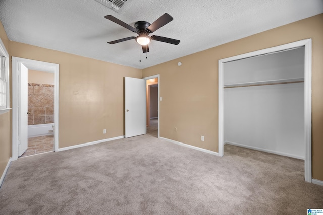 unfurnished bedroom featuring a closet, carpet, visible vents, and a textured ceiling