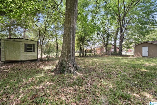 view of yard with a shed, an outdoor structure, and fence