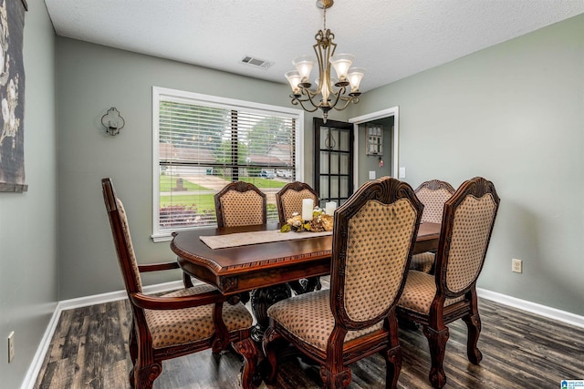 13563 Date St, Northport, AL 35475 - dining space with a chandelier, visible vents, baseboards, a textured ceiling, and wood finished floors