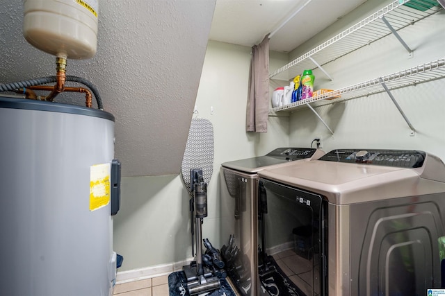 13563 Date St, Northport, AL 35475 - laundry area with baseboards, electric water heater, washer and clothes dryer, tile patterned floors, and laundry area
