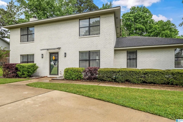13563 Date St, Northport, AL 35475 - colonial-style house with a chimney, brick siding, and a front yard