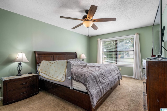 13563 Date St, Northport, AL 35475 - bedroom featuring a textured ceiling, ceiling fan, light colored carpet, and baseboards