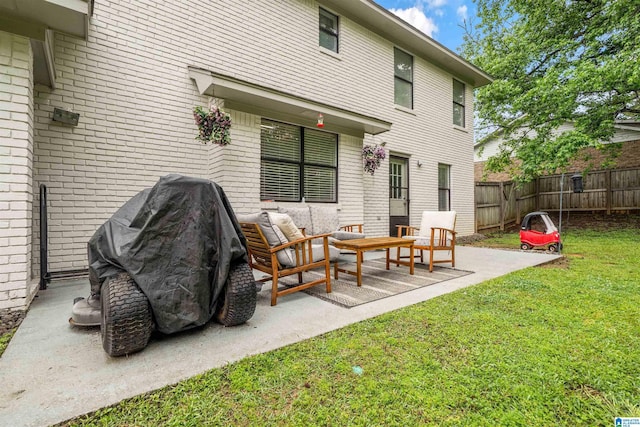13563 Date St, Northport, AL 35475 - rear view of house featuring a yard, brick siding, fence, a patio, and outdoor lounge area