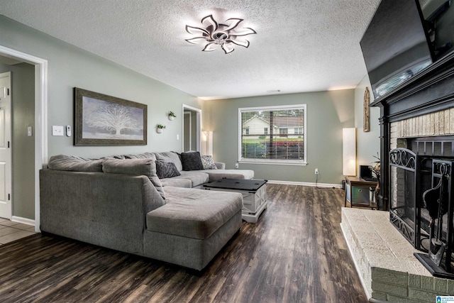 13563 Date St, Northport, AL 35475 - living room with baseboards, wood finished floors, a textured ceiling, and a fireplace