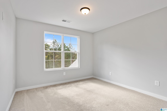 unfurnished room with baseboards, visible vents, and carpet floors