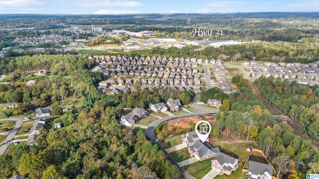 drone / aerial view featuring a residential view and a forest view