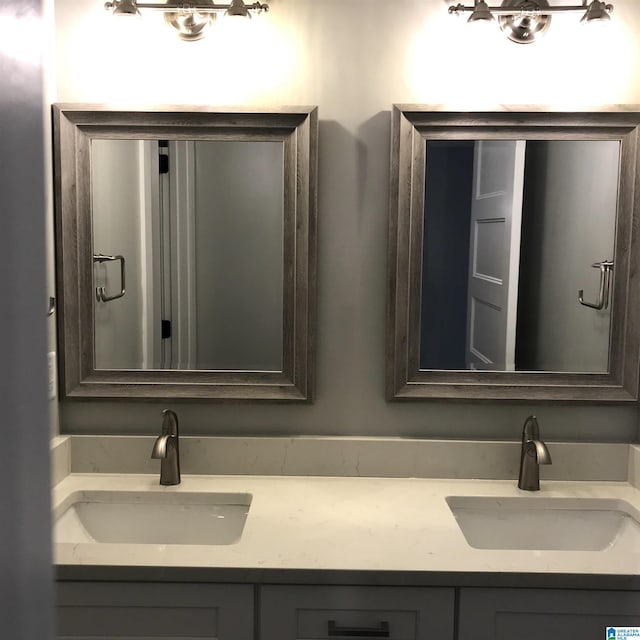 full bath with a sink and double vanity