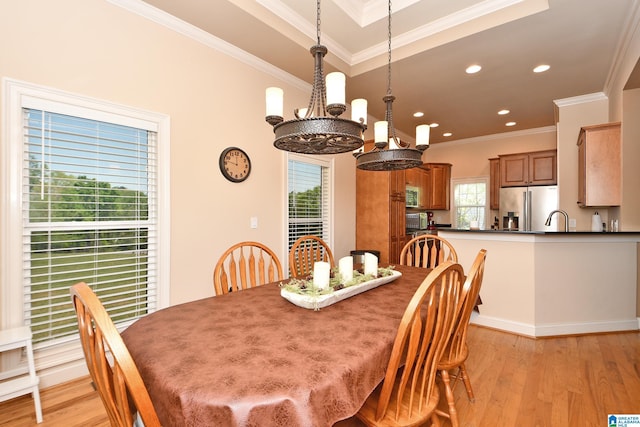 dining room featuring crown molding, a chandelier, and light wood-style floors