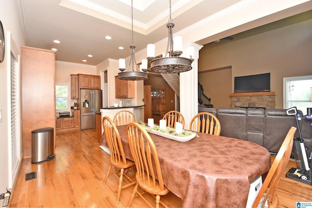 dining room with recessed lighting, a wealth of natural light, and light wood-style flooring