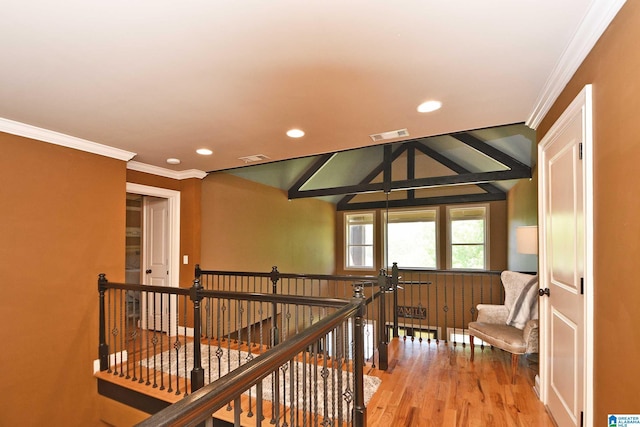 hall featuring recessed lighting, ornamental molding, and an upstairs landing