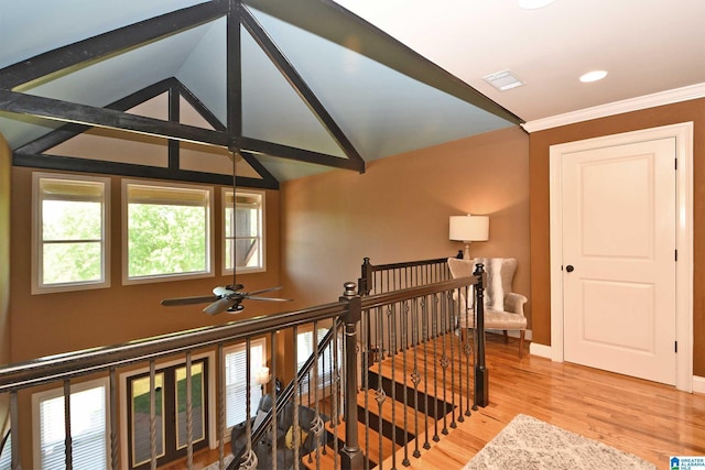 stairway featuring high vaulted ceiling, a ceiling fan, wood finished floors, baseboards, and visible vents