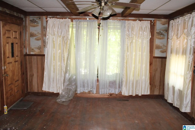 440 12th St W, Birmingham, AL 35208 - unfurnished room featuring a paneled ceiling, wooden walls, a ceiling fan, wainscoting, and wood finished floors