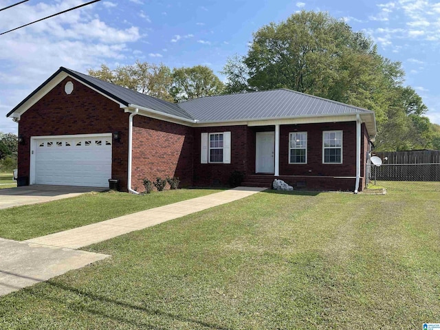 ranch-style house with metal roof, fence, a front lawn, brick siding, and a garage