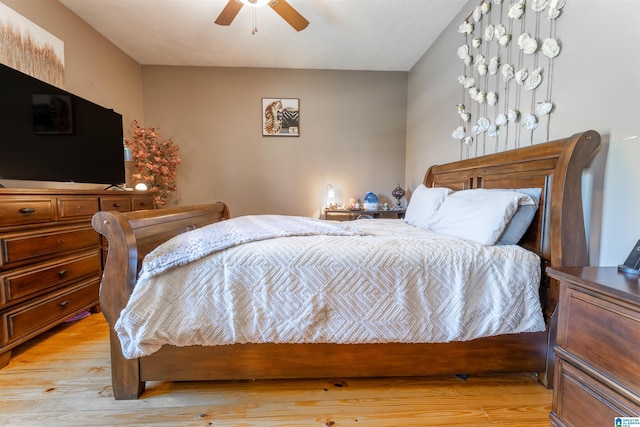 bedroom with ceiling fan and light wood-type flooring
