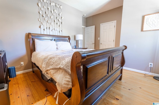 bedroom featuring wood finished floors and baseboards