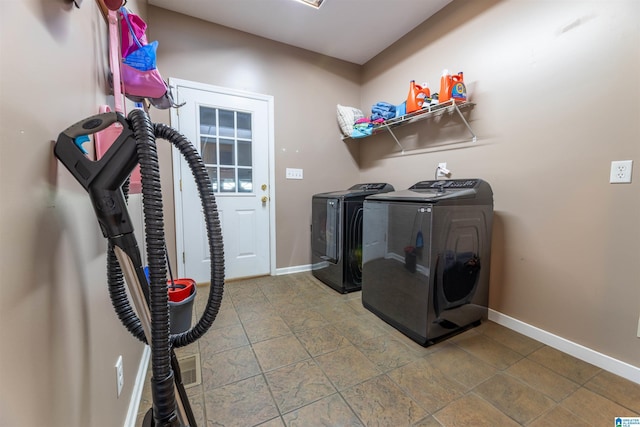 laundry area with baseboards, washer and clothes dryer, and laundry area